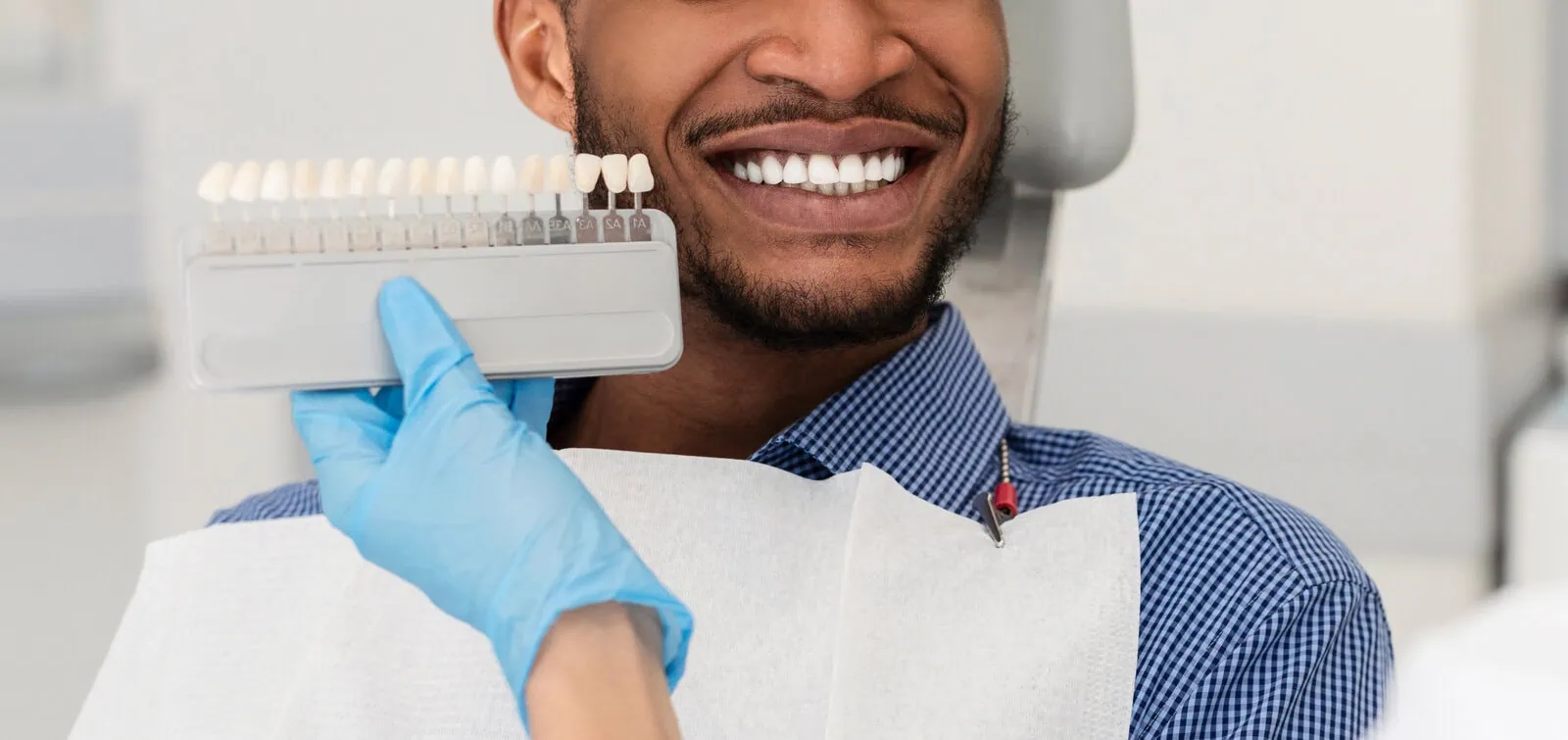 Patient admiring her new smile in a mirror
